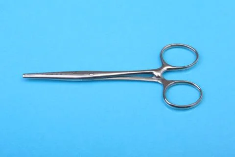 Close Up Surgical instruments and tools on blue mirror background. Selective Stock Photos