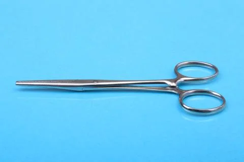 Close Up Surgical instruments and tools on blue mirror background. Selective Stock Photos
