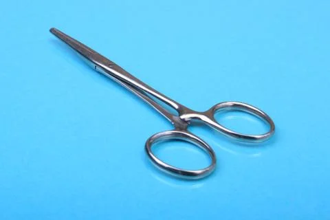 Close Up Surgical instruments and tools on blue mirror background. Selective Stock Photos