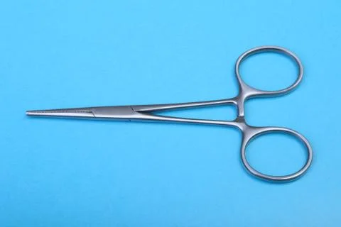Close Up Surgical instruments and tools on blue mirror background. Selective Stock Photos