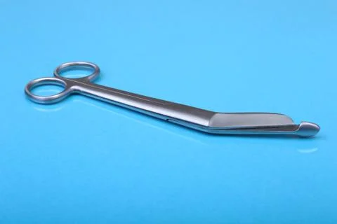 Close Up Surgical instruments and tools on blue mirror background. Selective Stock Photos