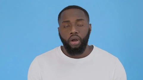 Close Up of Surprised Face of Young Man on blue Background 4K Stock Footage 117751852