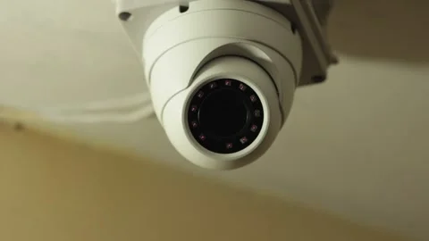 Close-up of a surveillance camera fixed inside a building. The cctv camera is in Stock Footage 240284831