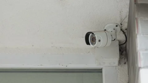 Close-up of a surveillance camera mounted on the facade of a building shop. Stock Footage 240284944