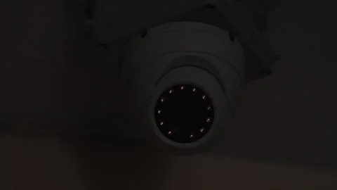 Close-up of a surveillance cctv camera fixed inside a building. The camera is in Stock Footage 240284777