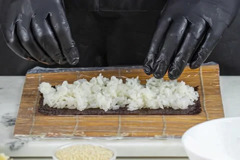 Close up of sushi chef hands preparing japanese food Stock Footage 152847322