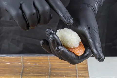 Close up of sushi chef hands preparing japanese food Stock Footage 152847323