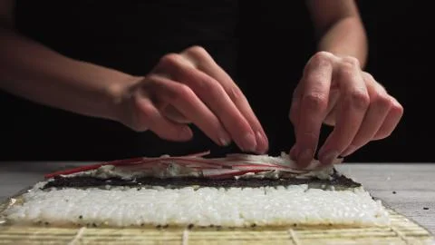 Close-up of Sushi Chef Hands puts crabs on a nori leaf and crab meat.Sushi Stock Photos