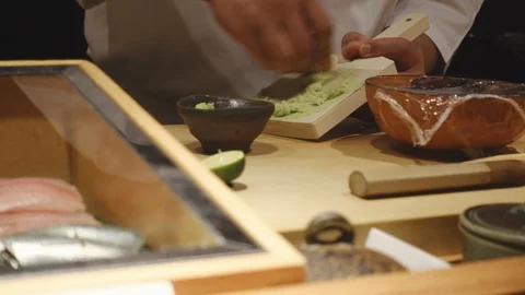 Close-up of a sushi chef preparing wasabi for customers Stock Footage 96228886