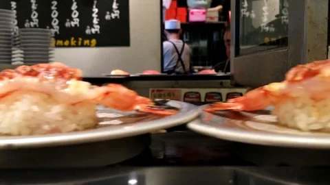 Close up of sushi dishes on a carousel Stock Footage 87857329