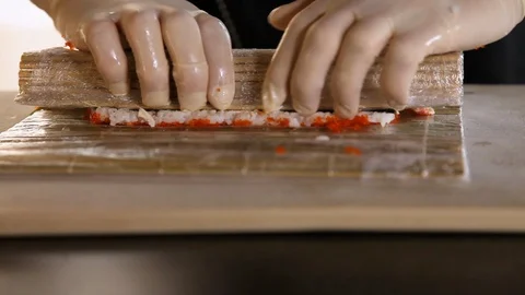 Close-up of Sushi making process.Rolls the sushi roll.Rice, nori, avocado, crab Stock Footage 119810987