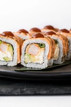 Close-up of sushi rolls made of sausage and covered with cabbage and ketchup Stock Photos