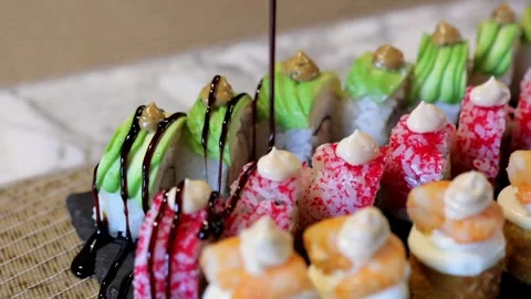 Close-up of Sushi Set Drizzled with Balsamic Vinegar Stock Footage 288578620