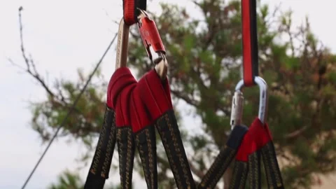 Close-up of suspended gear for the zip line with carabiners, ropes, fasteners Stock Footage 248529354