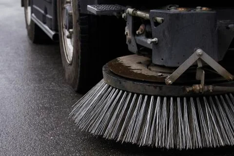 Close-up sweeper machine cleaning. Concept clean streets from debris. Selecti Stock Photos