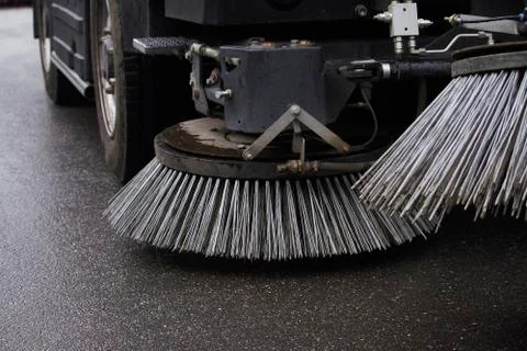 Close-up sweeper machine cleaning. Concept clean streets from debris. Selecti Stock Photos