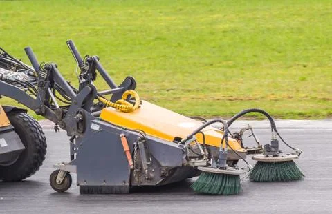 Close-up sweeper machine cleaning streets. Concept clean from debris. Stock Photos