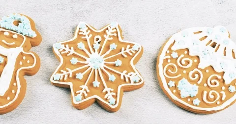 Close up of sweet gingerbread cookies with light blue stars sprinkles on grey te Stock Footage