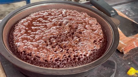 Close-up of sweet martabak batter bubbling as it cooks in a hot pan. Stock Footage 320477204