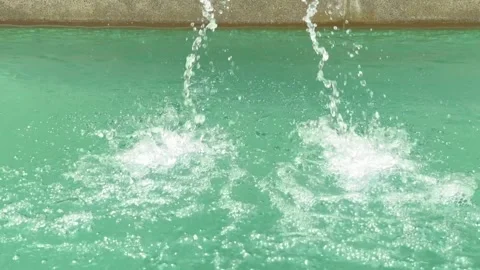 Close Up of Swimming Pool Waterfall Creating Refreshing Water Splash Stock Footage 337983183