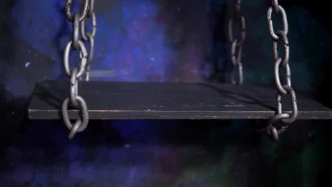 Close-up of a swing on chains in the dark. Stock Footage 311798080