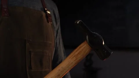 Close-Up on Swinging Blacksmith Hammer in Forge Stock Footage 255408742