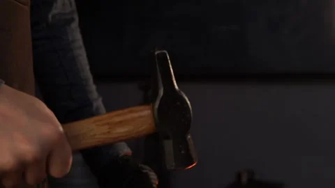 Close-Up on Swinging Blacksmith Hammer in Forge Stock Footage 255408772