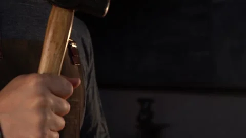 Close-Up on Swinging Blacksmith Hammer in Forge Stock Footage 255408773