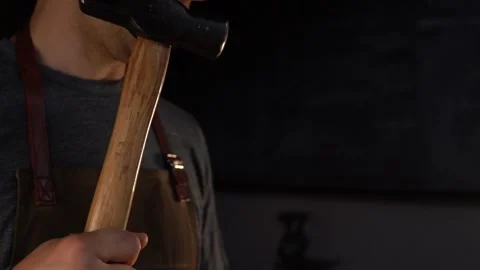 Close-Up on Swinging Blacksmith Hammer in Forge Stock Footage 255408829