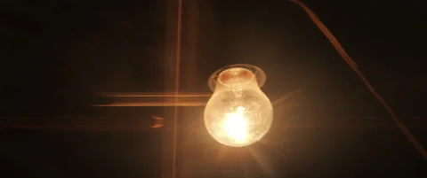 Close-up swinging light on old cord 5.7k scope video Stock Footage 310429606
