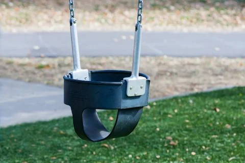 Close up of swings on empty playground Foto stock