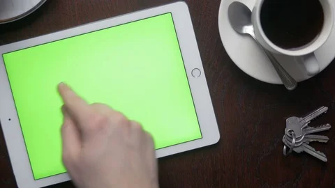 Close-up of swiping on the green screen of a tablet PC at home Stock Footage 75457768