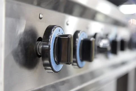 Close up switch of Kitchen burning gas cooker Stock Photos