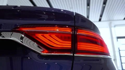 Close up of switched on tail lights of anonymous prestigious luxury modern car. Video stock 155755874