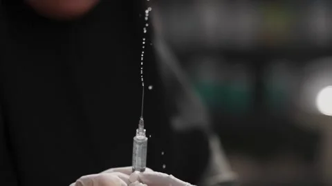 Close up of syringe dripping liquid Stock-Footage 345860613