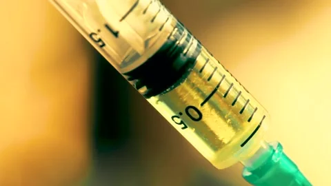 Close-up of syringe during injection Stock Footage 131500905