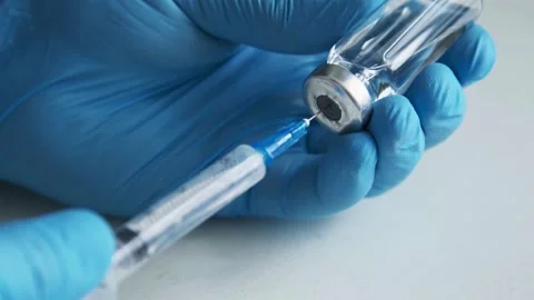 Close-up: Syringe ready for injection biotechnology and herd immunity building Stock Footage 336586962