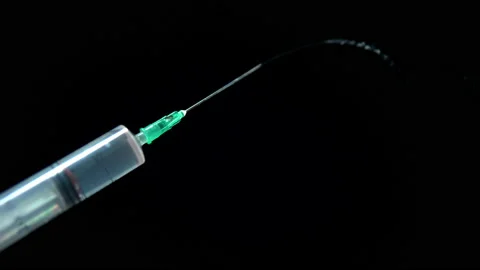 Close-up syringe squeezes out liquid and splashes Stock Footage 139714969