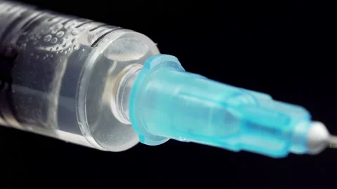Close-up of Syringe with Vaccine Solution. Medicine Injecting Using Syringe Stock Footage 159675980