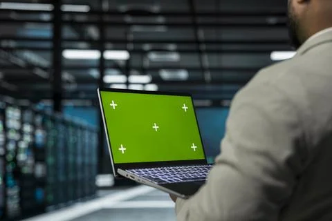 Close up of system administrator in data center using green screen Stock Photos