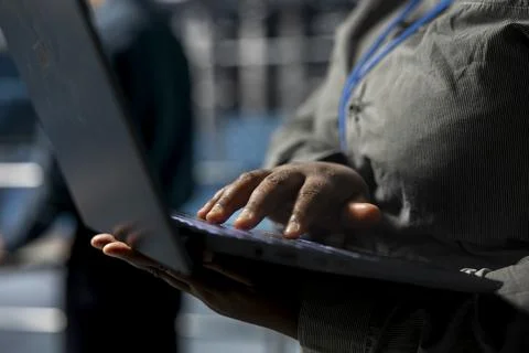 Close up of system administrator in data center using laptop Stock Photos