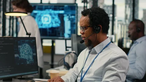 Close up of system administrator in office providing remote diagnostics Stock Footage 322697818