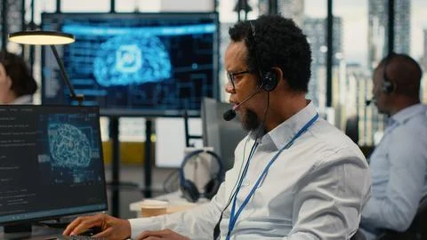 Close up of system administrator in office providing remote diagnostics 스톡 사진