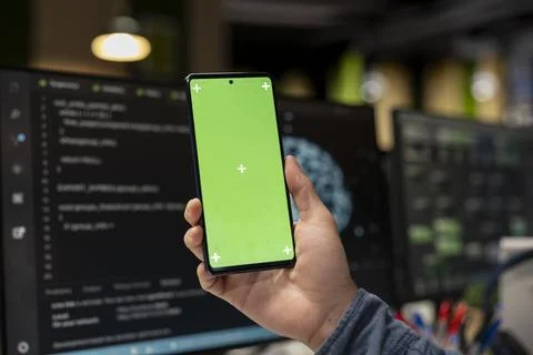 Close up of system administrator using green screen smartphone, debugging app 写真素材