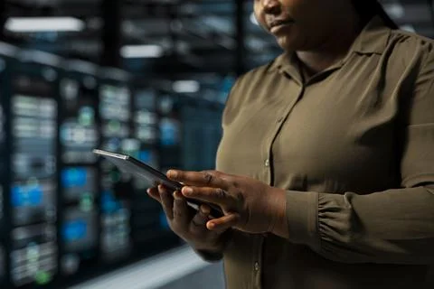 Close up of system administrator using tablet in data center to track metrics Stock Photos