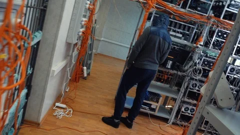 Close-up of system administrator working at data center room near the shelves Stock Footage 106229682