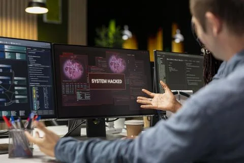 Close up of system administrators in office trying to fix hacking attempt 写真素材