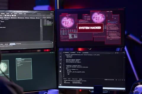 Close up of system hacked message on PC in empty underground lair used by hacker Stock Photos