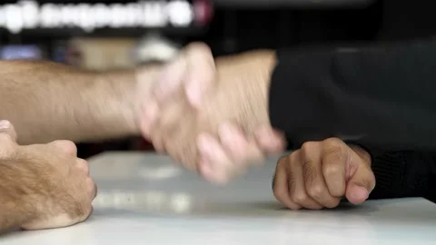 Close up of a table and hands of two men having interview or dialogue. Media Stock Footage 142579283
