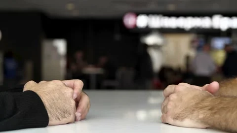 Close up of a table and hands of two men having interview or dialogue. Media Stock Footage 142630172